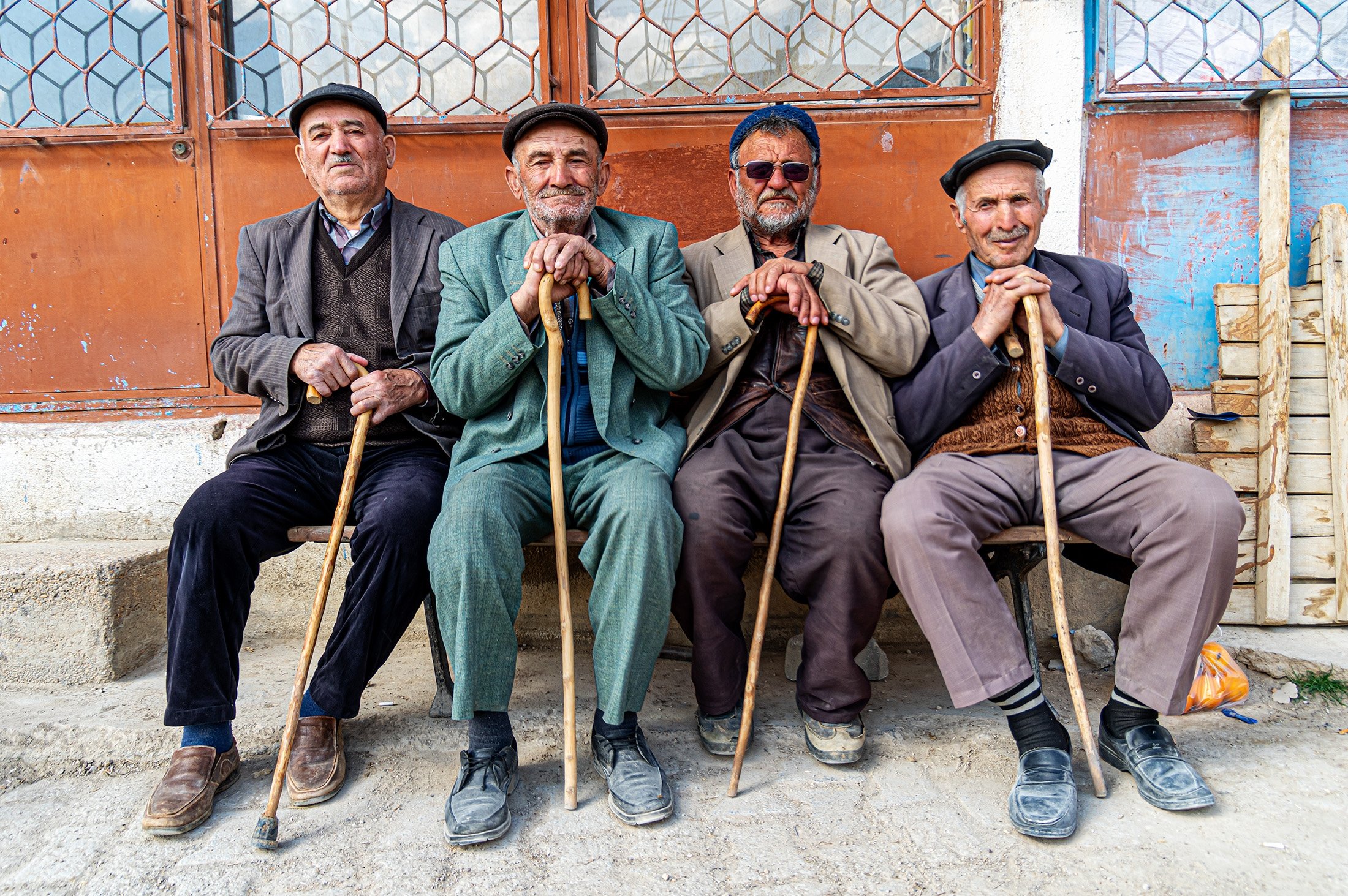 A group of elderly friends sit on a bench, ğposing with their canes in Mersin, southern Turkey, March 10, 2019. (Shutterstock Photo)