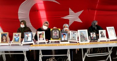 Mothers continue their sit-in protest in a tent displaying photos of their children abducted by the PKK terrorist group, set up outside the pro-PKK Peoples' Democratic Party (HDP) headquarters in Diyarbakır province, southeastern Turkey, Feb. 2, 2021. (AA Photo)