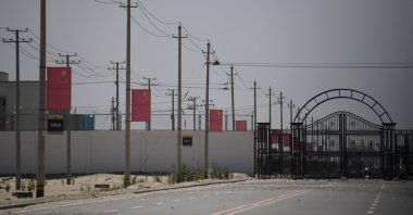 In this file photo, Chinese flags line a road leading to a facility believed to be a re-education camp where mostly Muslim ethnic minorities are detained, on the outskirts of Hotan in China's northwestern Xinjiang region, May 31, 2019. (AFP File Photo)