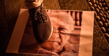 A demonstrator walks on a poster of U.S.-based Gülenist Terror Group (FETÖ) leader Fetullah Gülen in Taksim Square in Istanbul, Turkey, July 18, 2016. (AFP Photo)