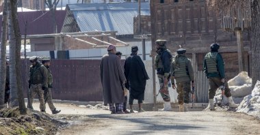 Paramilitary soldiers question Kashmiri villagers during a search operation in Beerwah area, Indian controlled Kashmir, Feb. 19, 2021. (AP Photo)