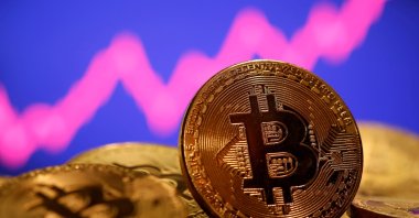 A representation of virtual currency Bitcoin is seen in front of a stock graph in this illustration taken on Jan. 8, 2021. (Reuters Photo)