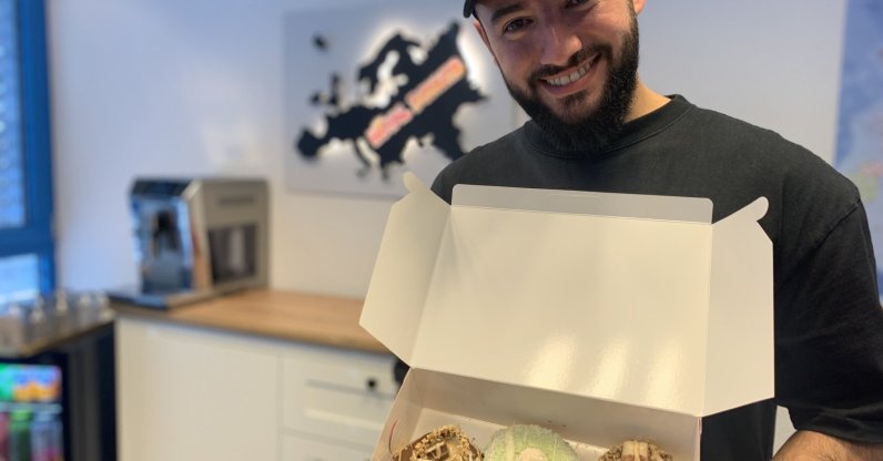 Enes Şeker shows a box of Royal Donuts in one of his stores in this photo provided on Feb. 19, 2021. (DHA Photo)