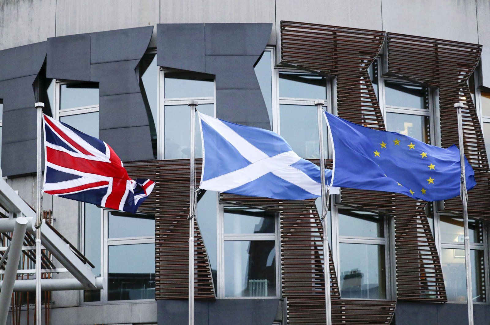 From left, the flags of Britain, Scotland and European Union wave outside the Scottish parliament in Edinburgh, Jan. 31, 2020. (AP Photo)