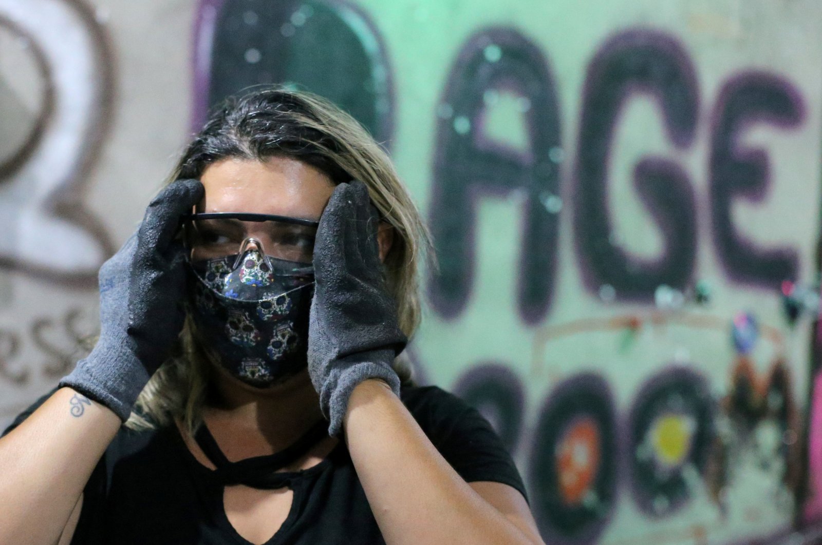 Luciana Holanda gets ready to use the Rage Room, a place where people can vent their anger on everyday items, such as bottles, broken TV sets and other electronic devices, in Sao Paulo, Brazil, Feb. 19, 2021. (Reuters Photo)