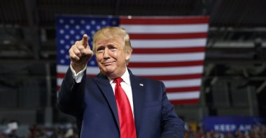 President Donald Trump gestures to the crowd as he arrives to speak at a campaign rally at Williams Arena in Greenville, U.S., July 17, 2019. (AP Photo)
