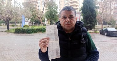 Ferit Aslan poses with his negative blood alcohol test in Mersin, Turkey, Feb. 21, 2021. (DHA Photo)