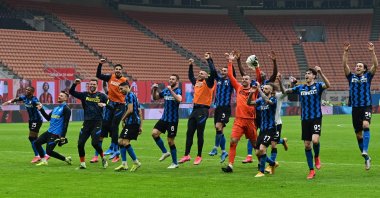 Inter players celebrate winning at the end of the Italian Serie A football match AC Milan vs Inter Milan at the San Siro stadium in Milan, Feb. 21, 2021. (AFP Photo)