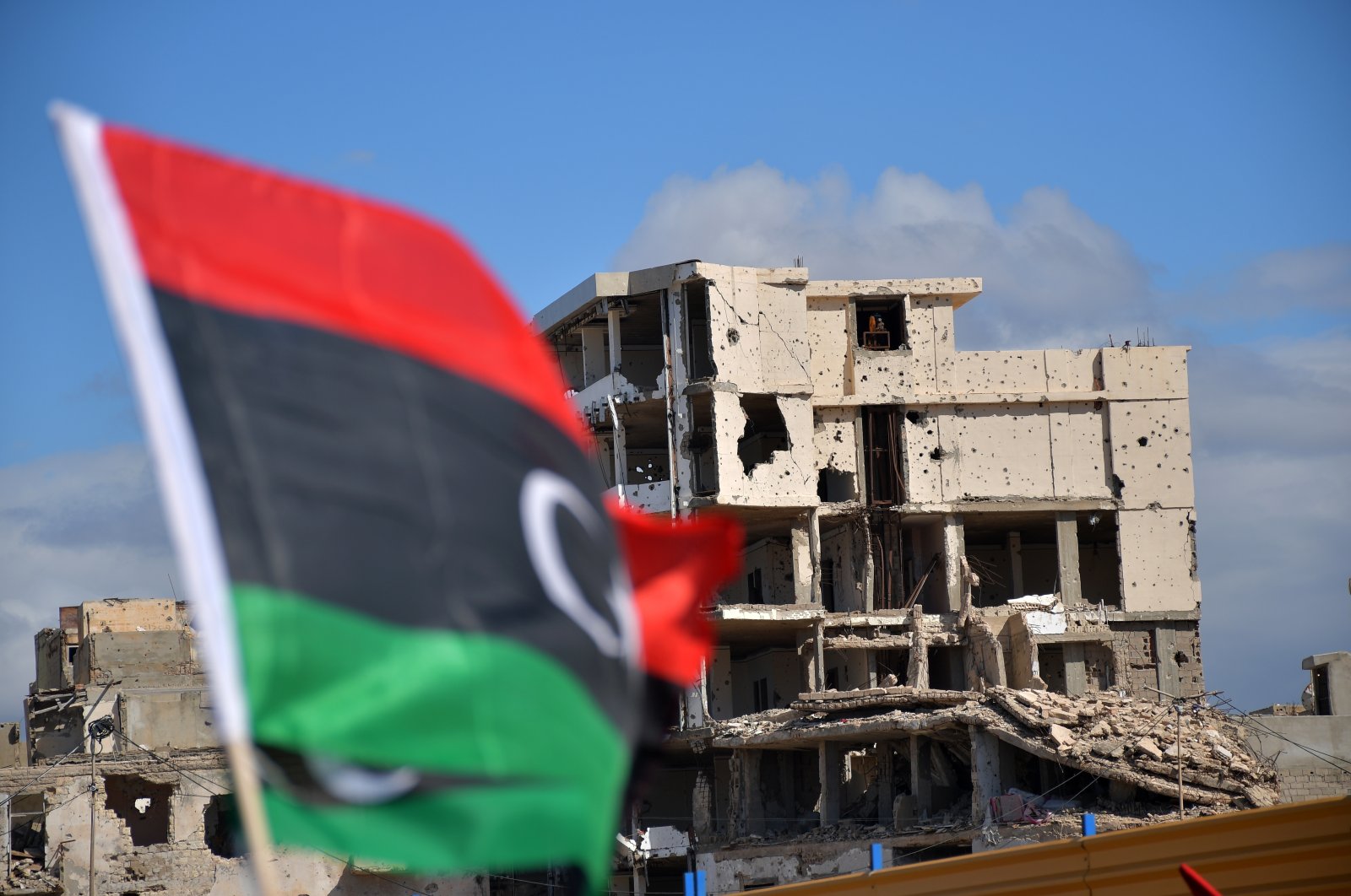 A damaged building is seen as Libyans mark the 10th anniversary of the 2011 uprising that led to the ousting and killing of longtime ruler Moammar Gadhafi, in Benghazi, Libya, Feb. 17, 2021. (AP Photo)