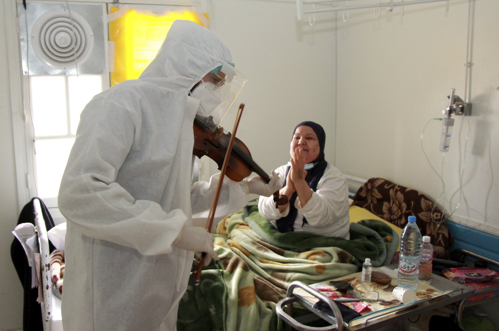 Dr. Mohamed Salah Siala plays the violin for patients on the COVID wards of the Hedi Chaker hospital in Sfax, eastern Tunisia, Feb. 20, 2021.  (AP Photo)
