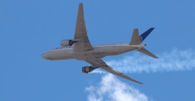 A photo provided by Instagram user Hayden Smith (speedbird5280) shows United Airlines flight 328 (Boeing 777-200, tailnumber N772UA) with an engine on fire, near Denver, Colorado, U.S., Feb. 20, 2021. (EPA Photo)