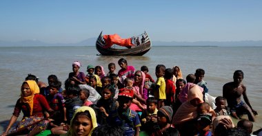 Rohingya refugees sit on a makeshift boat as they get interrogated by the Border Guard Bangladesh after crossing the Bangladesh-Myanmar border, at Shah Porir Dwip near Cox's Bazar, Bangladesh November 9, 2017. (Reuters Photo)