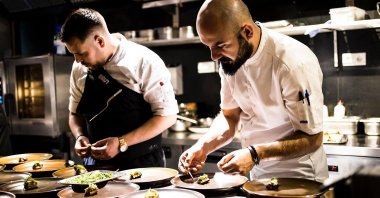 Michelin-starred Chef Ahmet Dede prepares food alongside another chef. (Archive Photo)