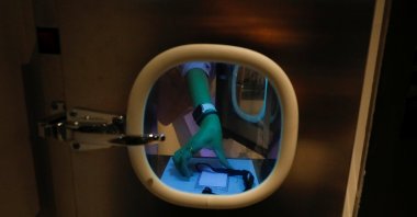 A staff member shows how documents could be sanitized and exchanged in a special window of a meeting room at short-stay facility Connect@Changi in Singapore on Feb 22, 2021. (REUTERS)