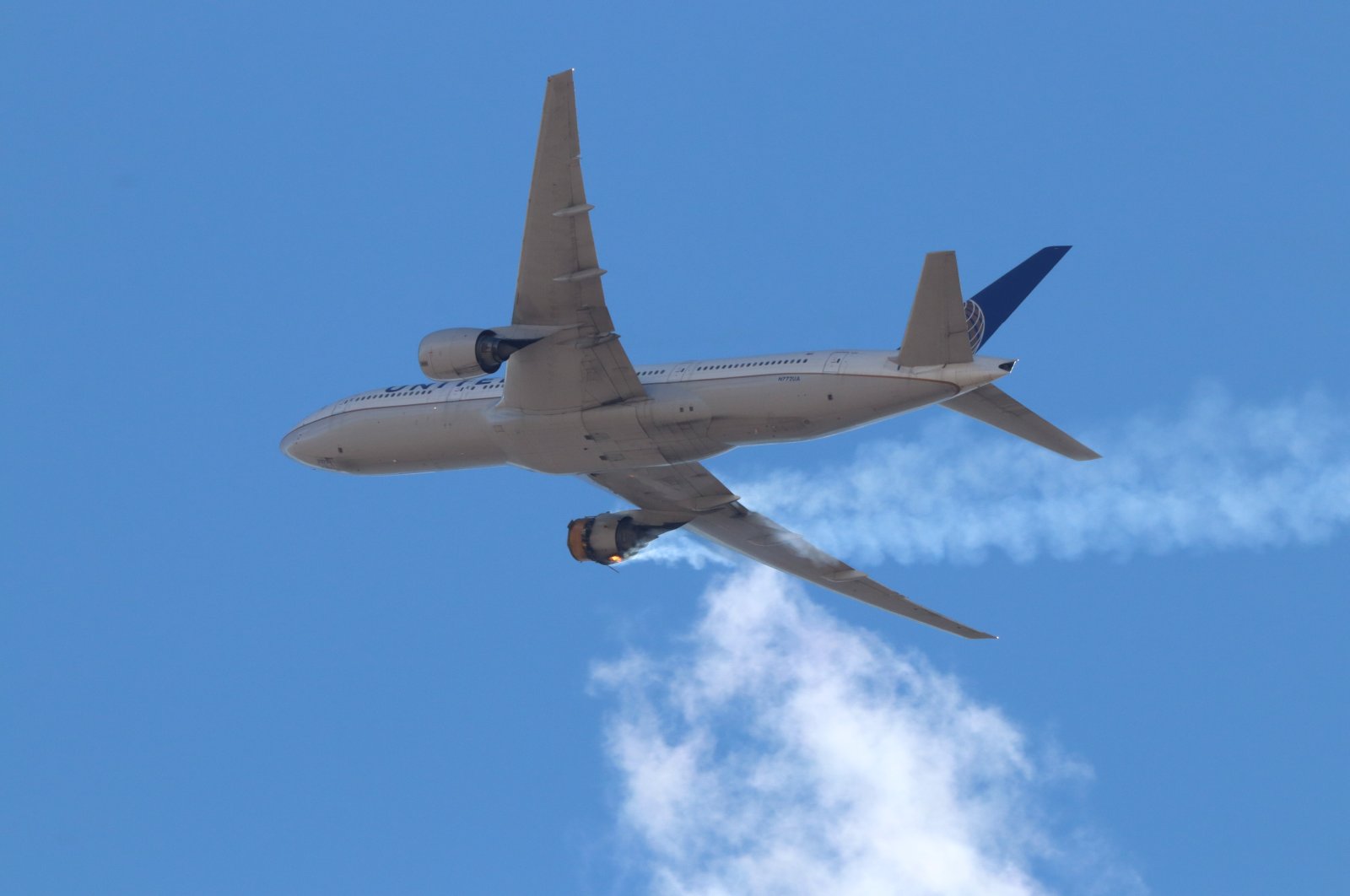 A photo provided by Instagram user Hayden Smith (speedbird5280) shows United Airlines flight 328 (Boeing 777-200, tailnumber N772UA) with an engine on fire, near Denver, Colorado, U.S., Feb. 20, 2021. (EPA Photo)