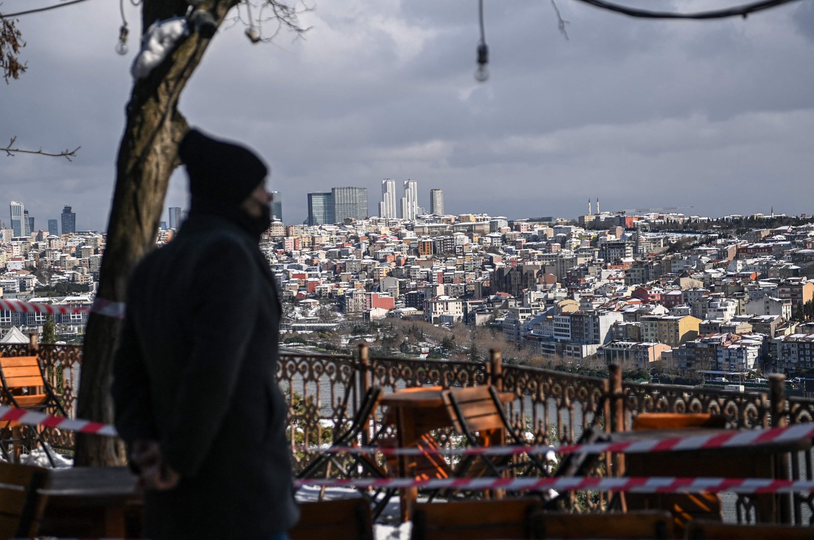 A man stands on Pierre Loti hill near the Eyüpsultan neighborhood in Istanbul after a heavy snowfall, Feb. 16, 2021. (AFP Photo)