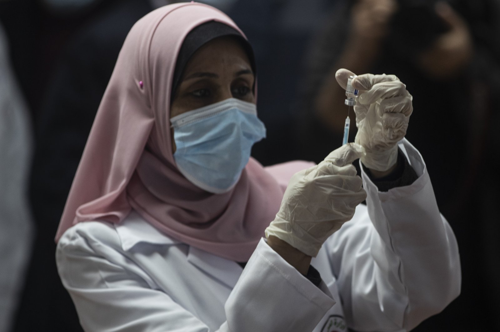 A Palestinian medic prepares a shot of the Russian-made Sputnik V coronavirus vaccine, in Gaza City, Feb. 22, 2021. (AP Photo)