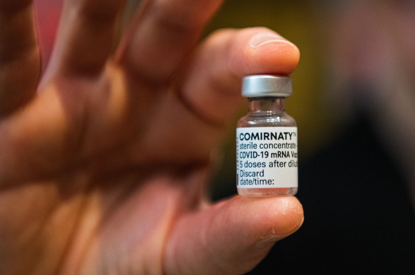 A medical worker holds a vial containing Comirnaty, Pfizer/BioNTech's vaccine against COVID-19 in Stockholm, Sweden on Feb. 21, 2021 (AFP).