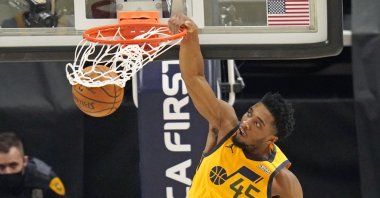 Utah Jazz guard Donovan Mitchell dunks against the Charlotte Hornets in an NBA basketball game in Salt Lake City, U.S., Feb. 22, 2021. (AP Photo)