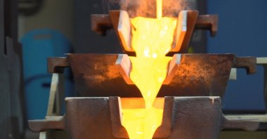 Melted gold is seen being put into bar shape in this undated file photo. (Photo courtesy of Alamos Gold)