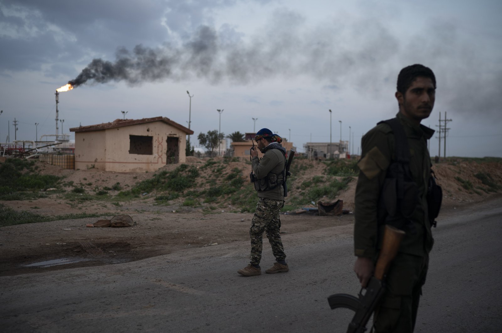 A YPG/PKK terrorist talks on his radio at a checkpoint near Omar oil field base, eastern Syria, Feb. 24, 2019. (AP File Photo)