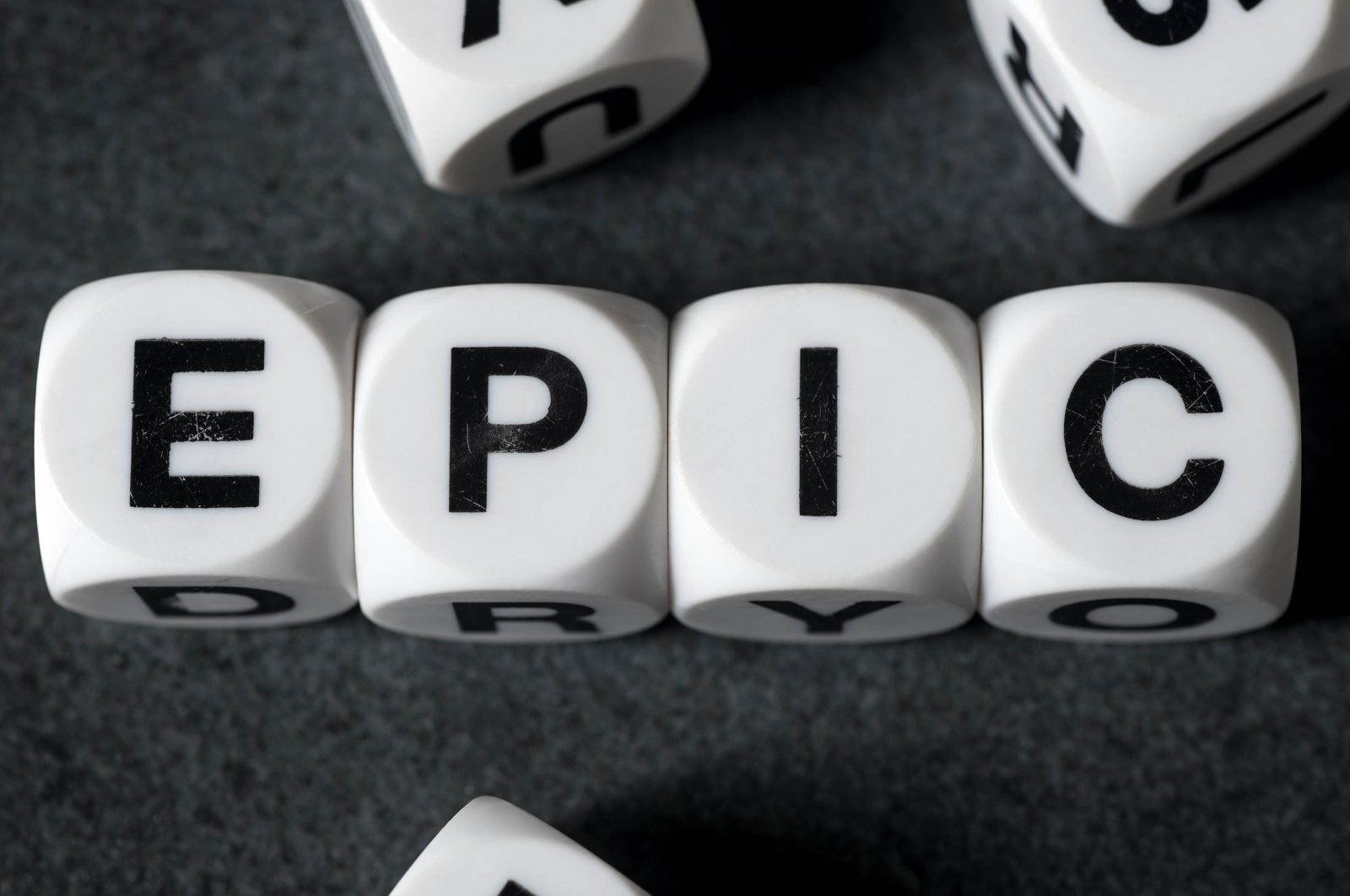 White toy cubes spelling out the word, “Epic.” (Shutterstock Photo)