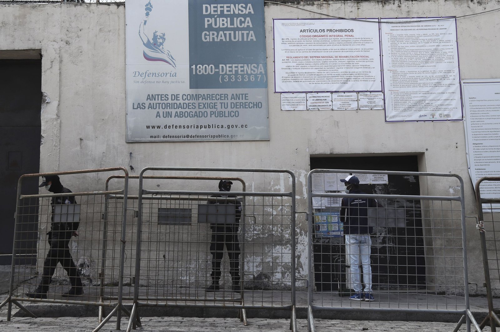 A man waits for information about a detained family member outside the Inca Center for Social Rehabilitation, in Quito, Ecuador, April 14, 2020. (AP Photo)