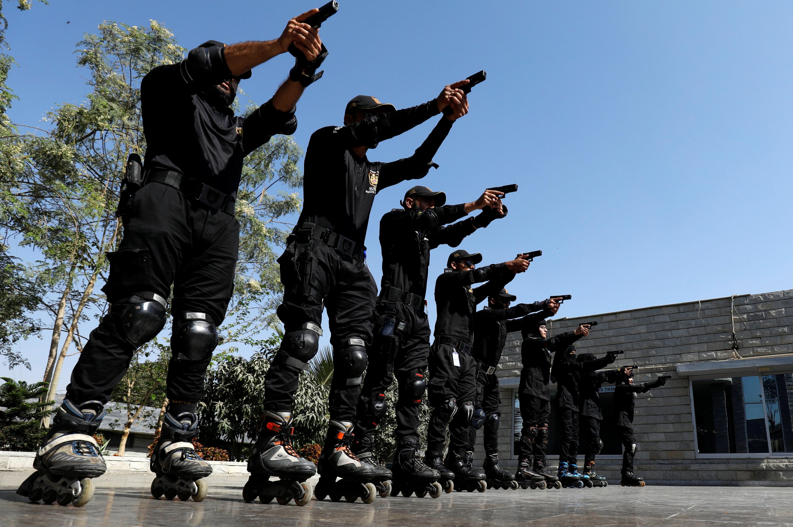 Special Security Unit (SSU) police members aim their weapons as they rollerblade during practice at the headquarters in Karachi, Pakistan, Feb. 18, 2021. (Reuters Photo)