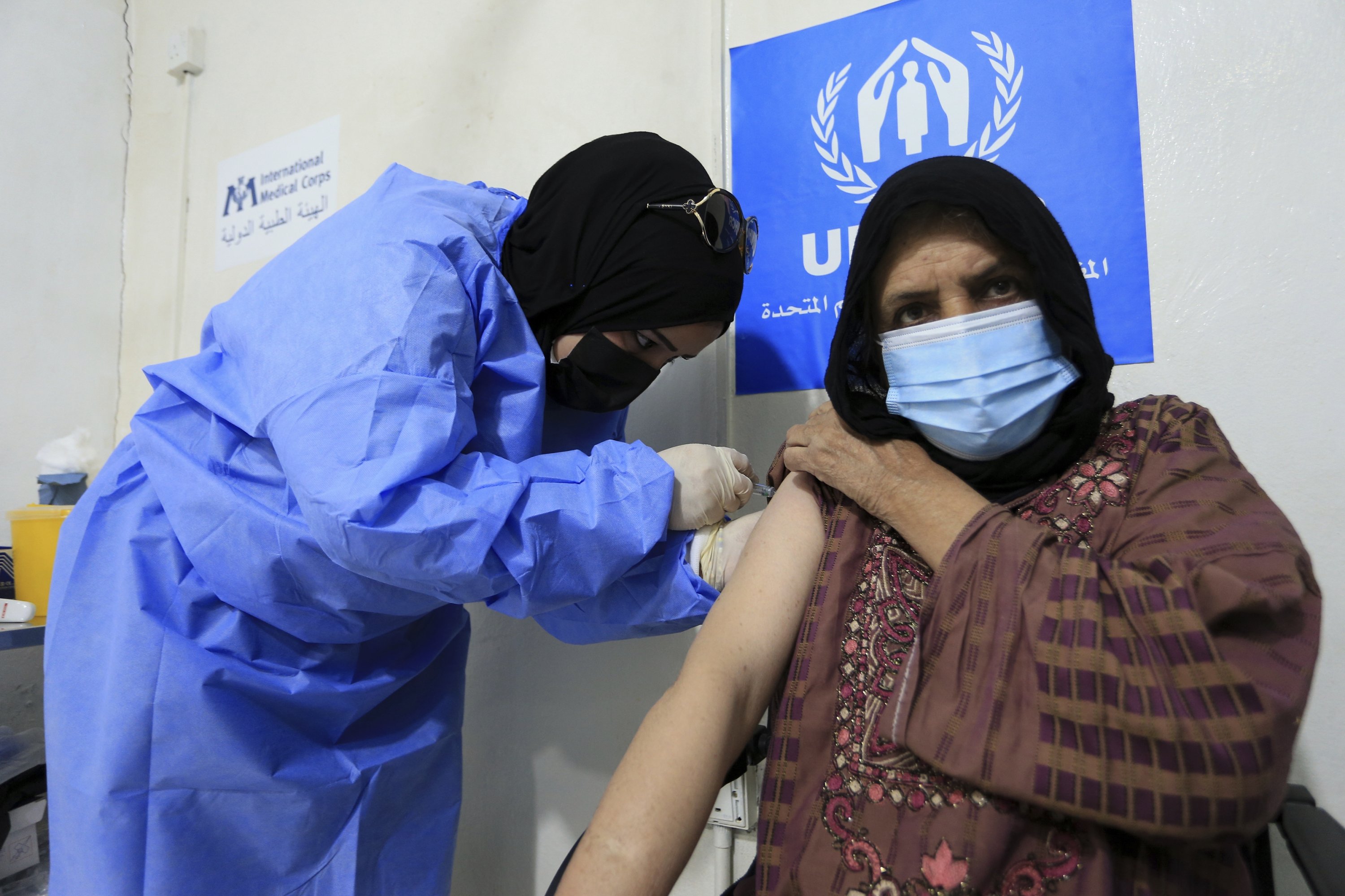 A Syrian refugee receives the Chinese-made Sinopharm COVID-19 vaccine at a medical center in the Zaatari refugee camp, in Mafraq, about 80 kilometers (50 miles) north of the capital Amman, Jordan, Feb. 15, 2021. (AP Photo/Raad Adayleh)