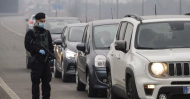 A Carabinieri officer patrols one of the main access roads to Bollate, in the outskirt of Milan, Italy, Feb. 18, 2021. (AP Photo)