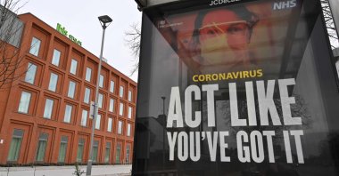 An NHS advertisement in front of an Ibis Styles hotel near London Heathrow Airport in west London, England, Feb. 14, 2021. (AFP Photo)