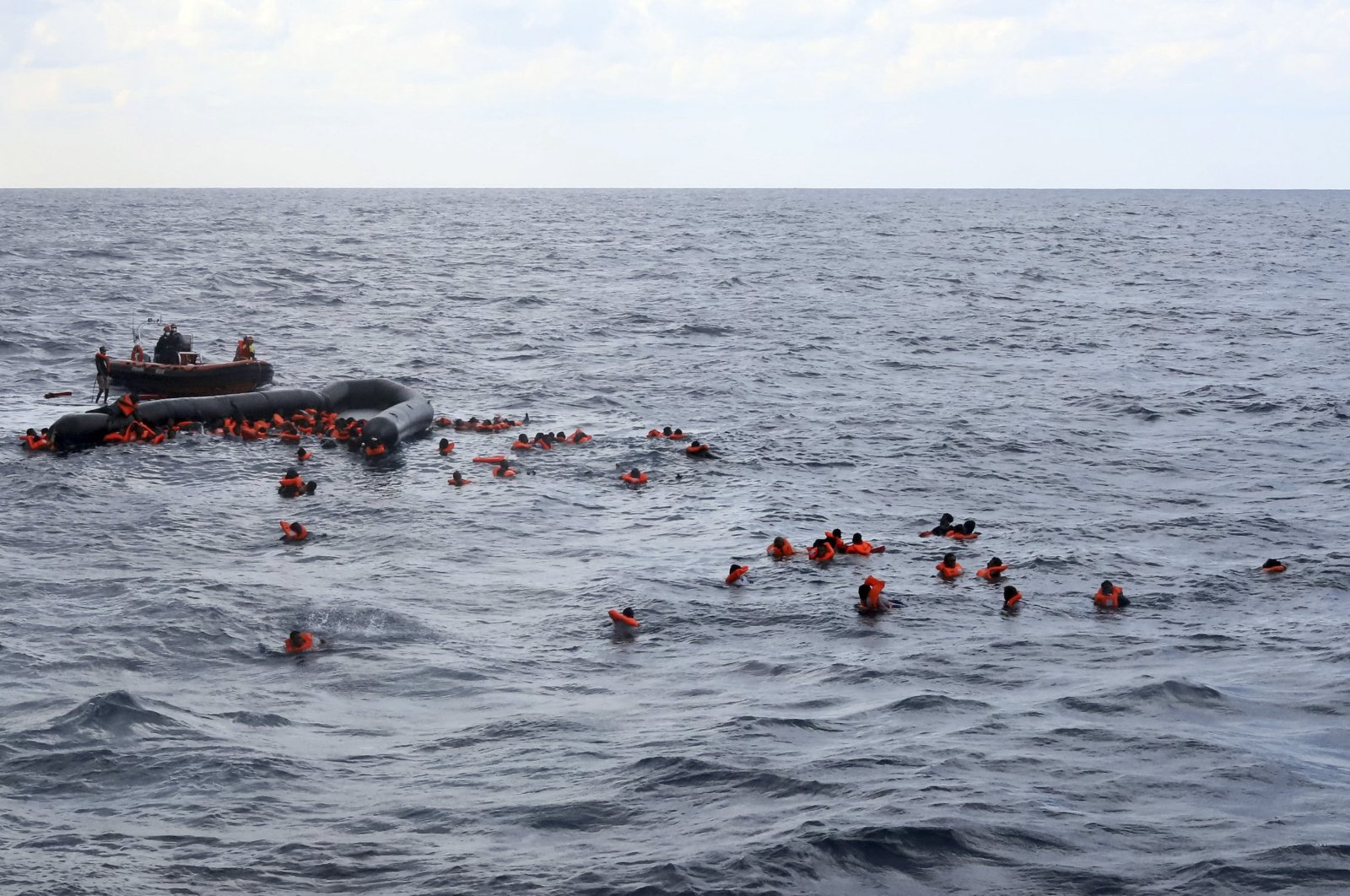 Refugees and migrants are rescued by members of the Spanish NGO Proactiva Open Arms, after leaving Libya trying to reach European soil aboard an overcrowded rubber boat in the Mediterranean Sea, Nov. 11, 2020. (AP Photo)