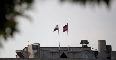 An Indian national flag (L) is hoisted next to a Jammu and Kashmir state flag on the government secretariat building after New Delhi scrapped the disputed region's semi-autonomy in Srinagar, Indian controlled Kashmir, Aug. 9, 2019. (AP Photo)