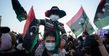 People wave flags and chant slogans to commemorate the 10th anniversary of the Arab Spring in Martyrs' Square, Tripoli, Libya, Feb. 17, 2021. (Photo by Getty Images)