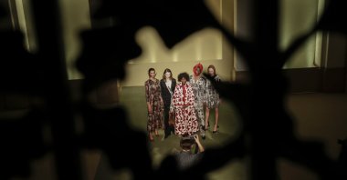 Fashion designer Fabiola Manirakiza, center, poses with models at the end of the Black Lives Matter Fall/Winter 2021/22 collective fashion show, presented in Milan, Italy, Feb. 17, 2021. (AP Photo)