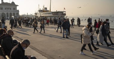 People wearing protective masks against the coronavirus spread walk by the seaside in Kadıköy district, Istanbul, Turkey, Feb. 23, 2021. (Photo by Getty Images)