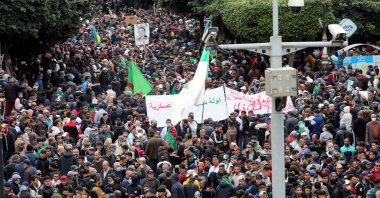 Demonstrators carry banners and flags as they march to mark the second anniversary of a mass protest movement demanding political change, in Algiers, Algeria, Feb. 22, 2021. (Reuters Photo)
