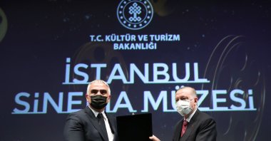 Culture and Tourism Minister Mehmet Nuri Ersoy (L) along with President Recep Tayyip Erdoğan during the opening of the Atlas Theatre and İstanbul Cinema Museum, Istanbul, Turkey, Feb. 26, 2021. (AA Photo)