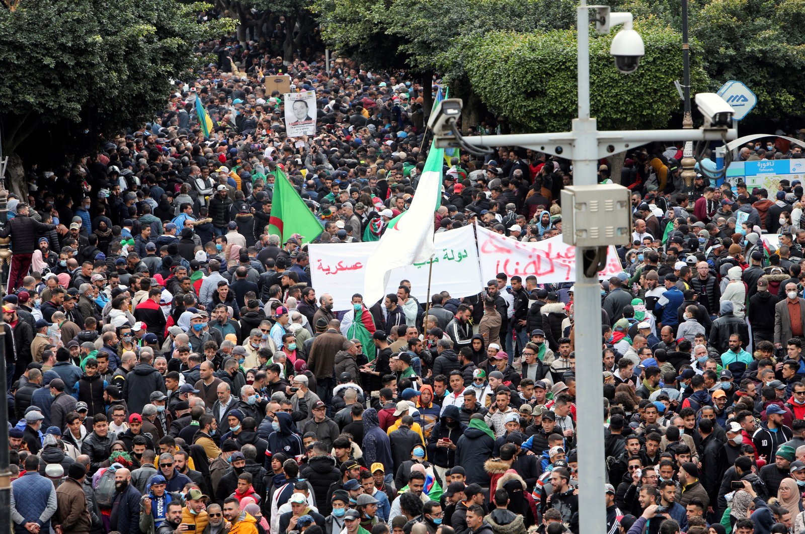 Demonstrators carry banners and flags as they march to mark the second anniversary of a mass protest movement demanding political change, in Algiers, Algeria, Feb. 22, 2021. (Reuters Photo)