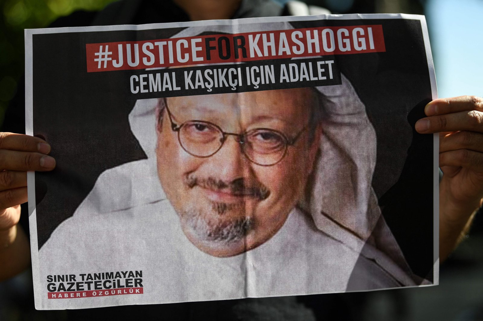 Friends of murdered Saudi journalist Jamal Khashoggi hold posters bearing his picture as they attend an event marking the second-year anniversary of his assassination in front of Saudi Arabia's Istanbul Consulate, Istanbul, Turkey, Oct. 2, 2020. (AFP Photo)
