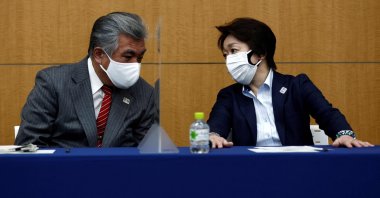 Tokyo 2020 Vice Director-General Yukihiko Nunomura (L) speaks with President of the Tokyo 2020 Olympics Organising Committee Seiko Hashimoto before the press briefing on operations and media coverage of the Tokyo 2020 Olympic Torch Relay in Tokyo, Japan, on Feb. 25, 2021. (AFP Photo)