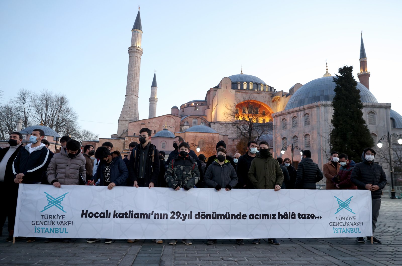 People hold a banner during an event commemorating Khojaly Massacre victims near the Hagia Sophia Grand Mosque in Istanbul, Turkey, Feb. 26, 2021. (AA Photo)