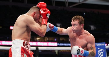 Turkey's Avni Yıldırım (L) defends against Mexico's Saul "Canelo” Alvarez during their World Boxing Council and World Boxing Association belts match at the Hard Rock Stadium, Miami, Florida, Feb. 27, 2021.