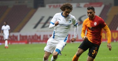 Galatasaray's Egyptian striker Mostafa Mohamed (R) goes past Erzurumspor's Osman Çelik (L) in a Süper Lig match at the Türk Telekom Stadium, Istanbul, Turkey, Feb. 27, 2021.