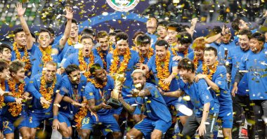 Jiangsu Suning players and staff members celebrating after winning the Chinese Super League (CSL) football championship in Suzhou, eastern China, Nov. 12, 2020. (AFP Photo)