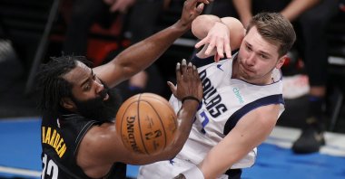Dallas Mavericks' Luka Doncic (R) passes the ball as Brooklyn Nets' James Harden (L) defends during an NBA match at Barclays Center, New York, Feb. 27, 2021. (AFP Photo)