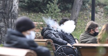 People smoke electronic cigarettes at a park in the capital Ankara, Turkey, Nov. 16, 2020. (DHA PHOTO) 