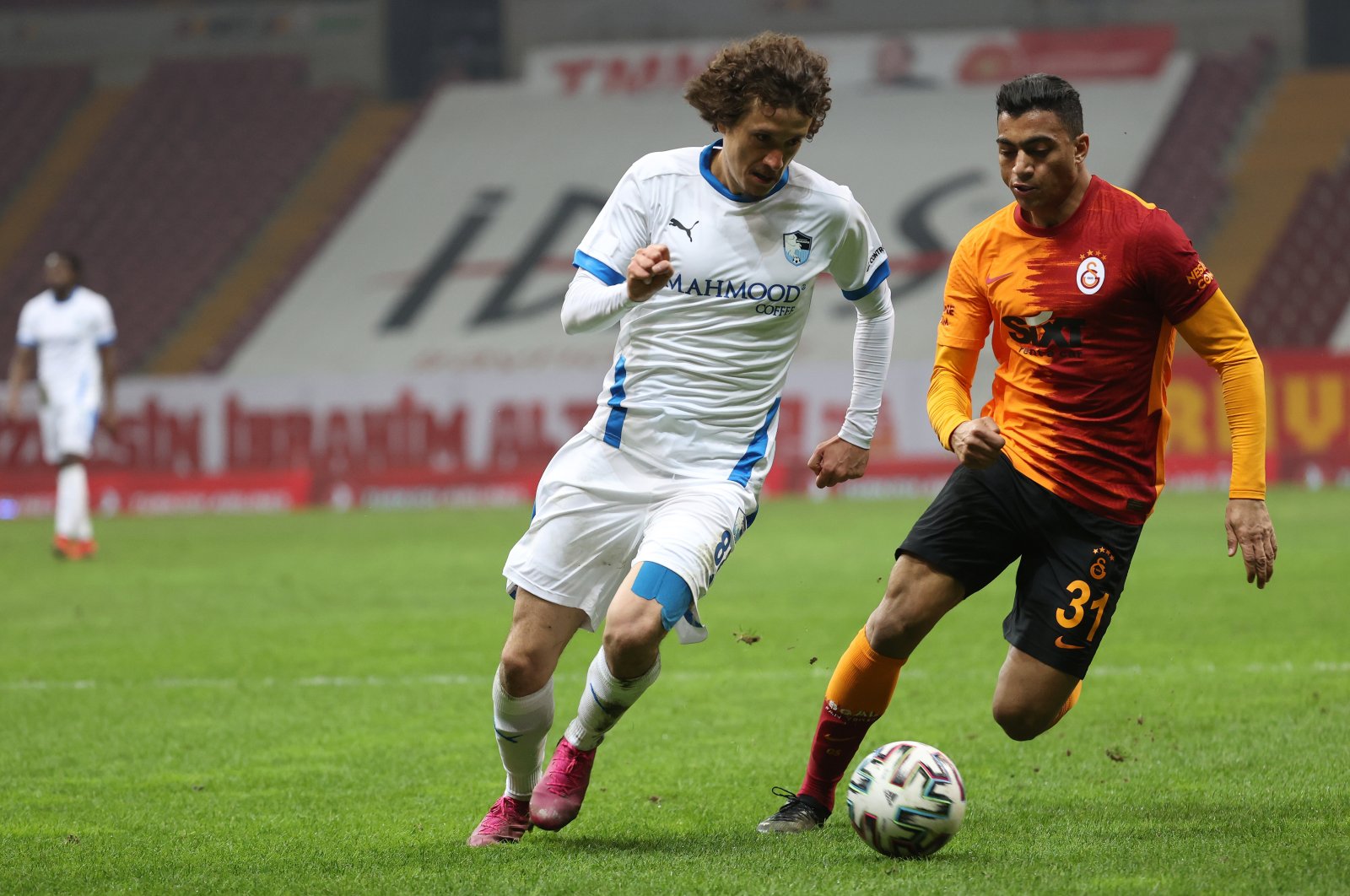 Galatasaray's Egyptian striker Mostafa Mohamed (R) goes past Erzurumspor's Osman Çelik (L) in a Süper Lig match at the Türk Telekom Stadium, Istanbul, Turkey, Feb. 27, 2021.