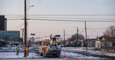 An Oncor Electric Delivery crew works on restoring power to a neighborhood following the winter storm that passed through Texas in Odessa, Texas, U.S., Feb. 18, 2021. (AP Photo)