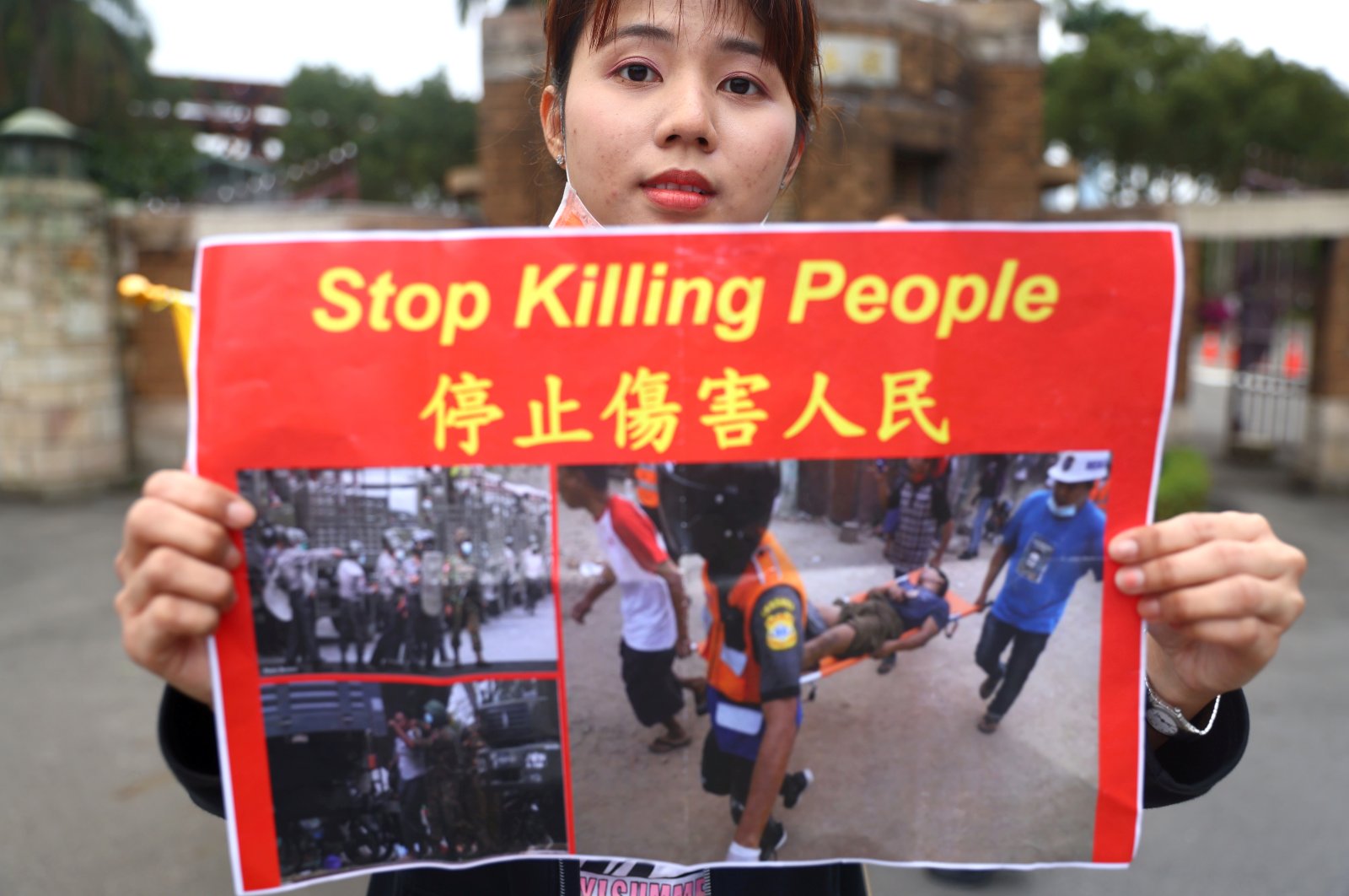 A woman holds up a poster against the Myanmar military coup as part of the Milk Tea Alliance united rally in Taipei, Taiwan, Feb. 28, 2021. (Reuters Photo)